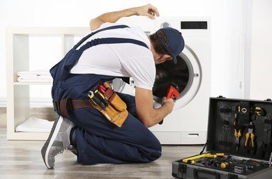 plumber-repairing-washing-machine-260nw-587730830